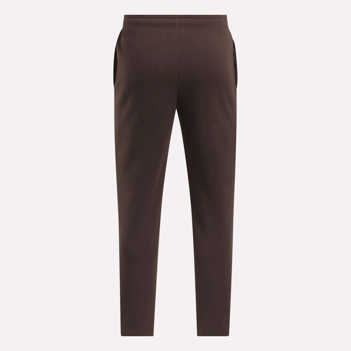 The Reebok Men's Patent Pants in brown are shown flat from the back on a light background, featuring an elastic waistband and side pockets. Made with a cotton-poly blend for comfort and durability.