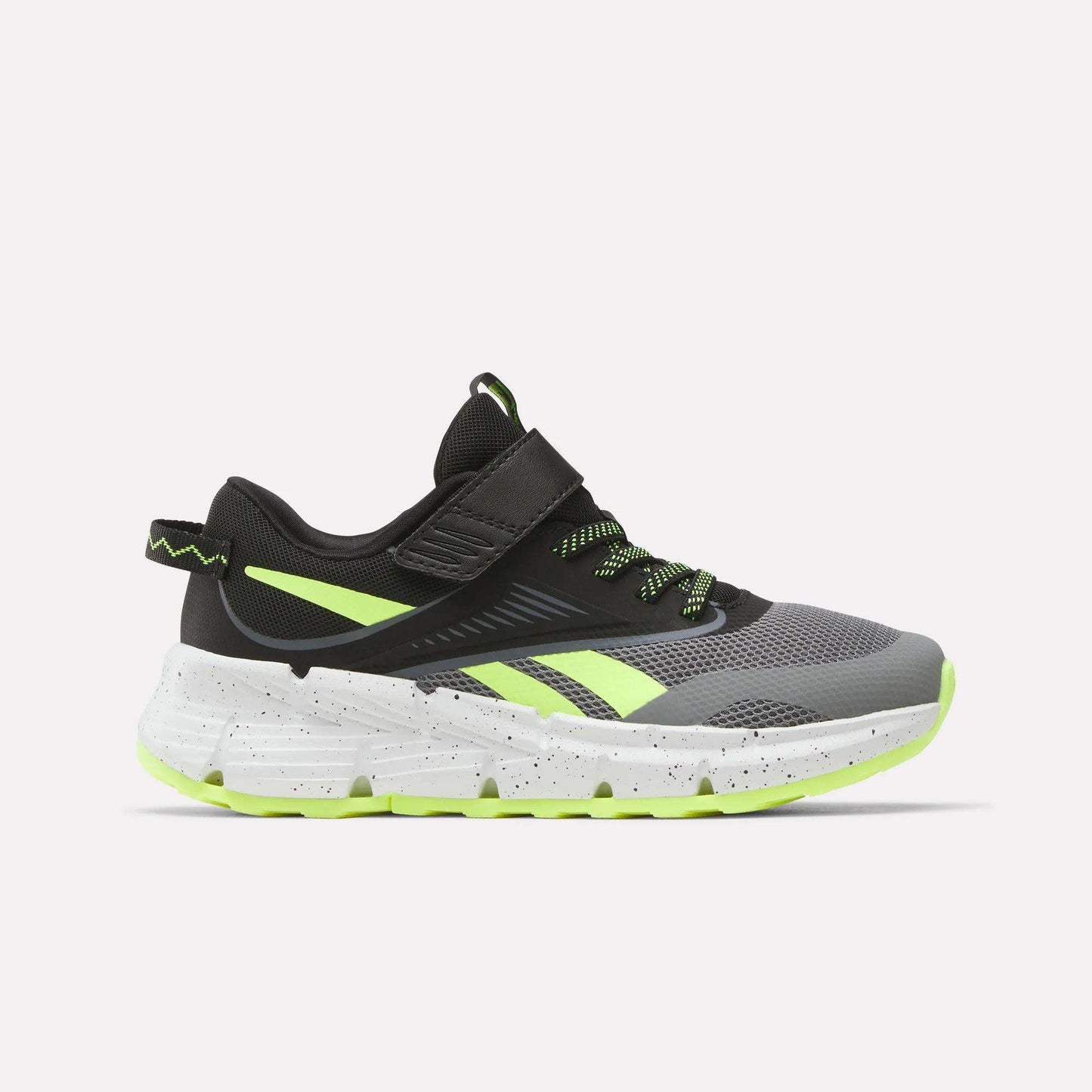 The Reebok Zig Dynamica 6 Running Shoes for little kids, in Grey 4/Black/Digital Lime, feature a mesh upper, neon accents, Zig technology in the white speckled sole, and a hook-and-loop strap. Shown from the side on a plain white background.
