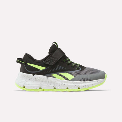 The Reebok Zig Dynamica 6 Running Shoes for little kids, in Grey 4/Black/Digital Lime, feature a mesh upper, neon accents, Zig technology in the white speckled sole, and a hook-and-loop strap. Shown from the side on a plain white background.