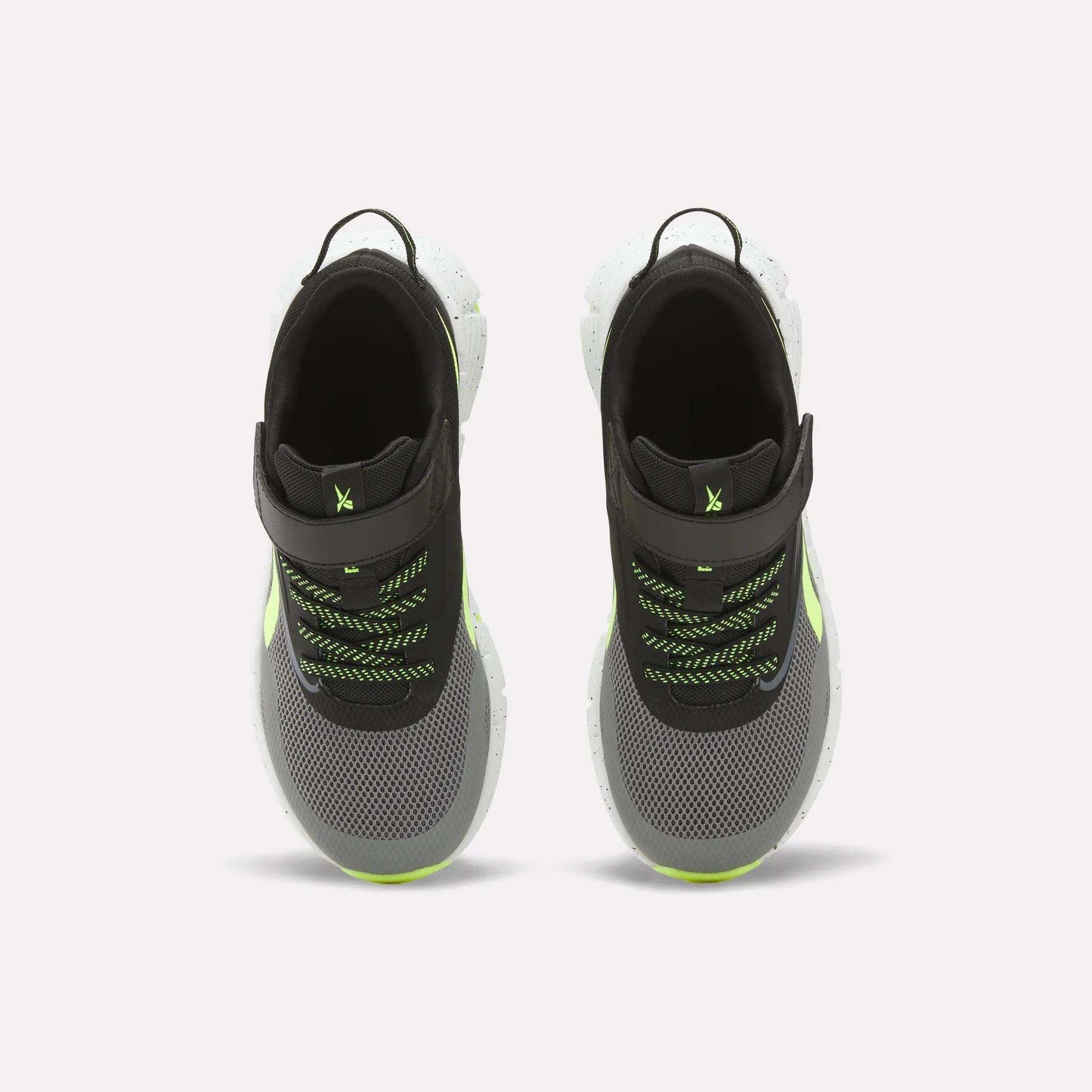 Top view of Reebok Zig Dynamica 6 Running Shoes for little kids in black and gray with neon green accents, white Zig soles, mesh uppers, black pull tabs, and green/black laces on a white background.
