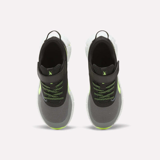 Top view of Reebok Zig Dynamica 6 Running Shoes for little kids in black and gray with neon green accents, white Zig soles, mesh uppers, black pull tabs, and green/black laces on a white background.