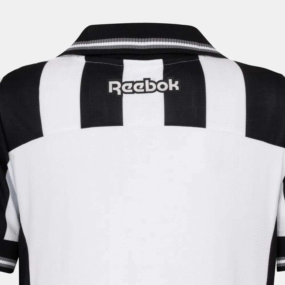 Back view of the Kids' Botafogo Youth Home Jersey by Reebok, featuring black and white stripes, a black collar, and a white Reebok logo on the upper back—a stylish 25/26 football shirt.