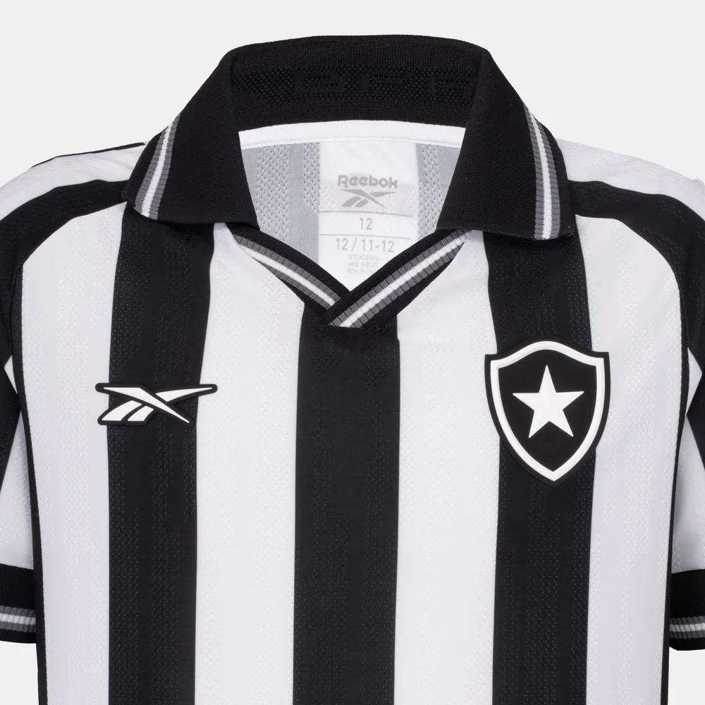The Kids' Botafogo Youth Home Jersey by Reebok features classic black and white stripes, a collar, the Reebok logo on one side, and a shield with a white star—perfect for young fans of the 25/26 home shirt design.