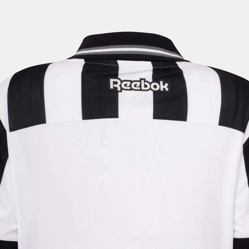 Back view of the Botafogo Women's Home Jersey by Reebok, featuring black and white stripes, a black collar, and the white "Reebok" logo on the upper back, styled as the 25/26 home football shirt.