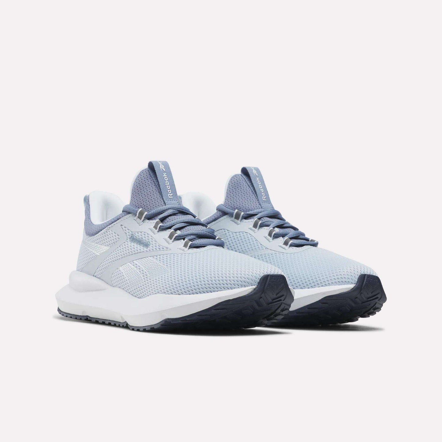 The Reebok Women's Cityride 2 Running Shoes in light gray and blue feature mesh uppers, lace-up closures, FuelFoam cushioning, and textured rubber soles, shown on a white background.