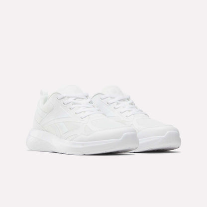 A pair of all-white Reebok Rush Runner 6.0 Running Shoes for big kids, featuring laces, mesh, and synthetic material, displayed on a plain white background.
