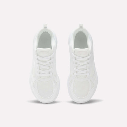 Top view of Reebok Rush Runner 6.0 Running Shoes for big kids, in clean white with white laces, minimalist design, and EVA midsole, placed side by side on a light background.