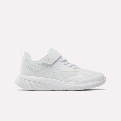 The Reebok Rush Runner 6.0 Elastic Lace Top Strap Running Shoes for little kids feature a white design with mesh and synthetic overlays, a hook-and-loop strap, low profile, and textured sole—shown side view on white. Ideal kids' running shoes.