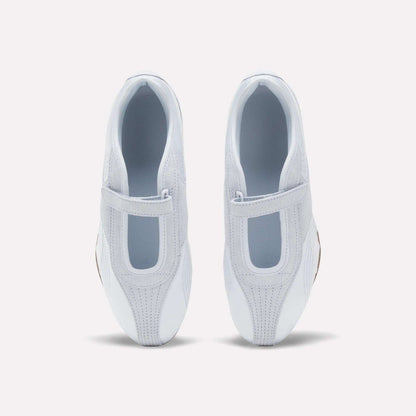 Top view of Women's Ultra Lo Mary Jane Shoes by Reebok in white, featuring Velcro straps and T-shaped cutouts on each upper, displayed on a plain white background with a subtle nod to the mary jane silhouette.