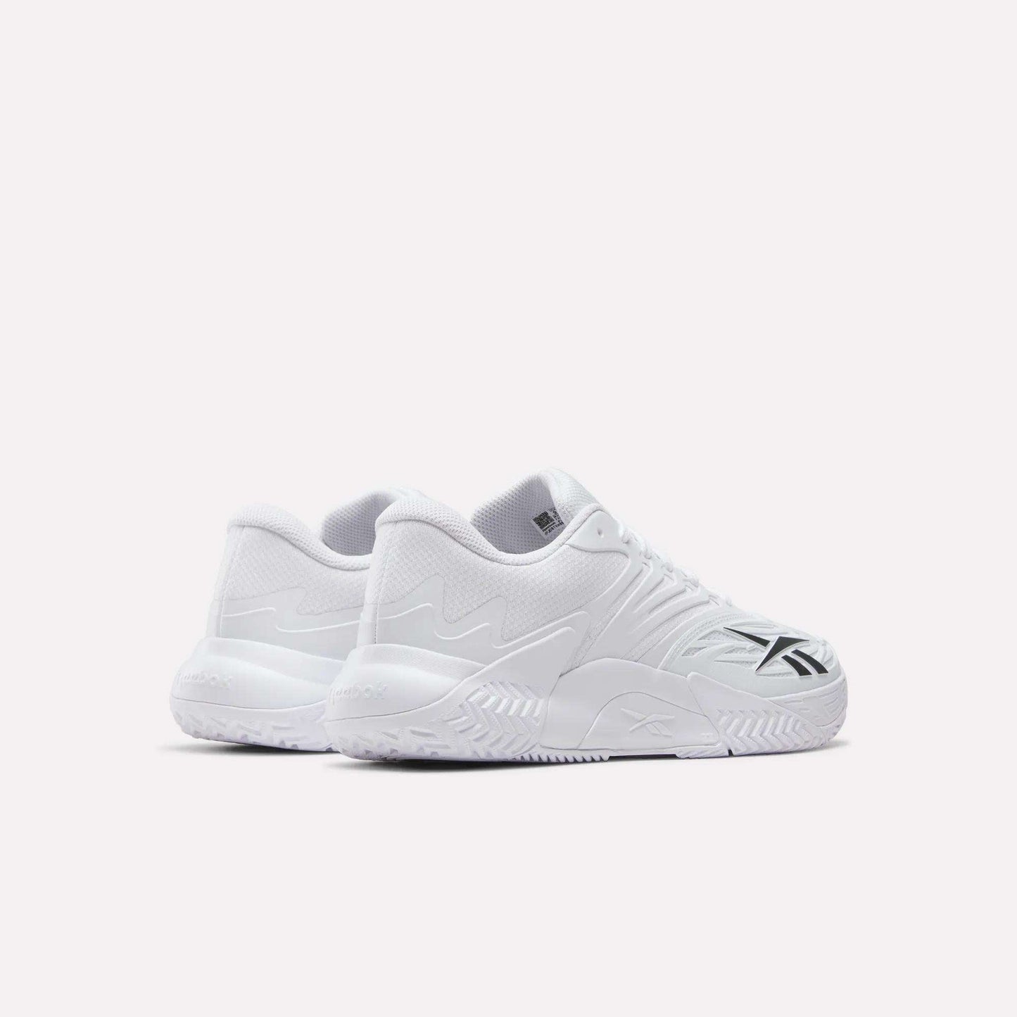 A pair of Reebok Phase EVO Tennis Shoes in white with textured soles and black side accents, shown on a plain white background. Both the outer and rear views of the sneakers are visible in the image.