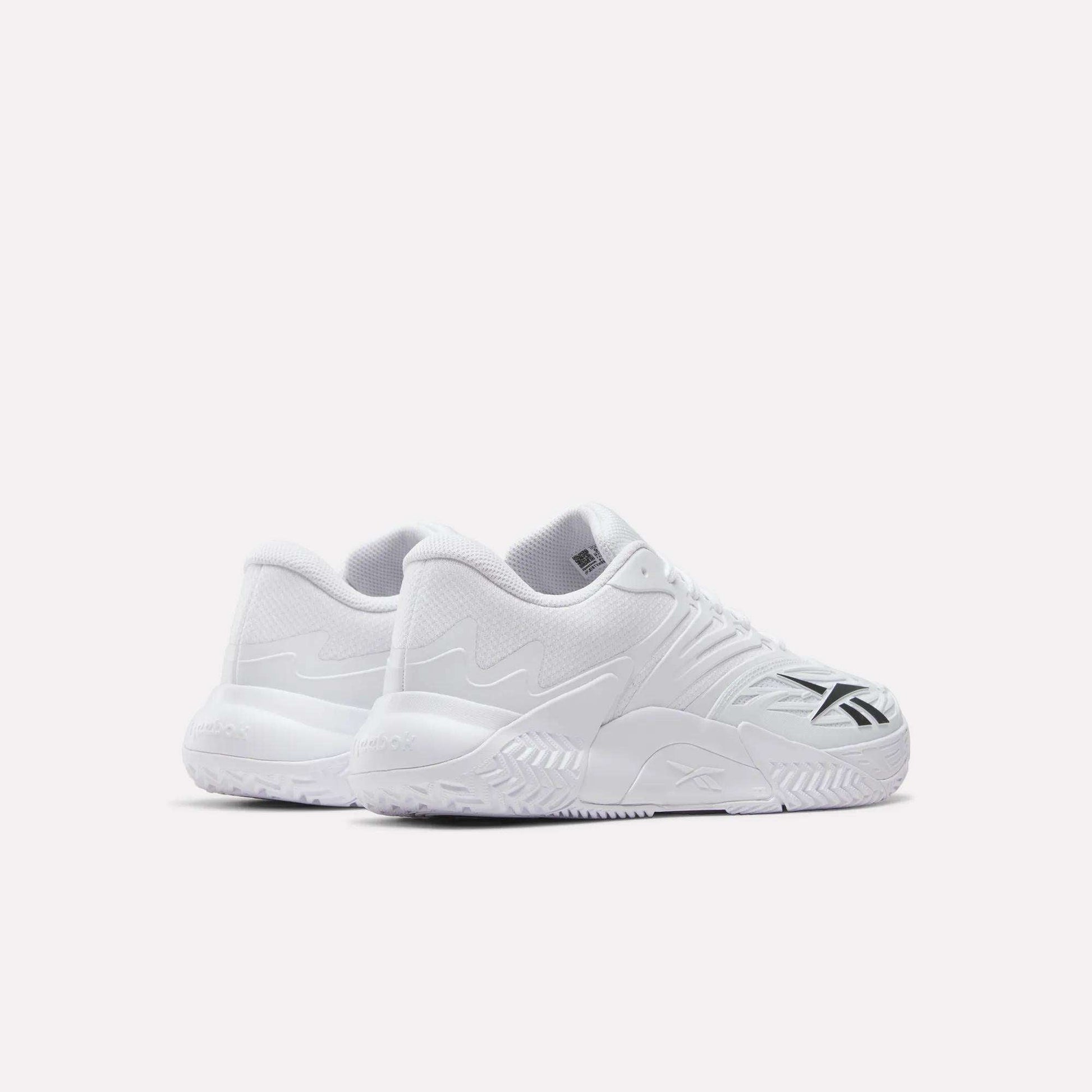 A pair of Reebok Phase EVO Tennis Shoes in white with textured soles and black side accents, shown on a plain white background. Both the outer and rear views of the sneakers are visible in the image.