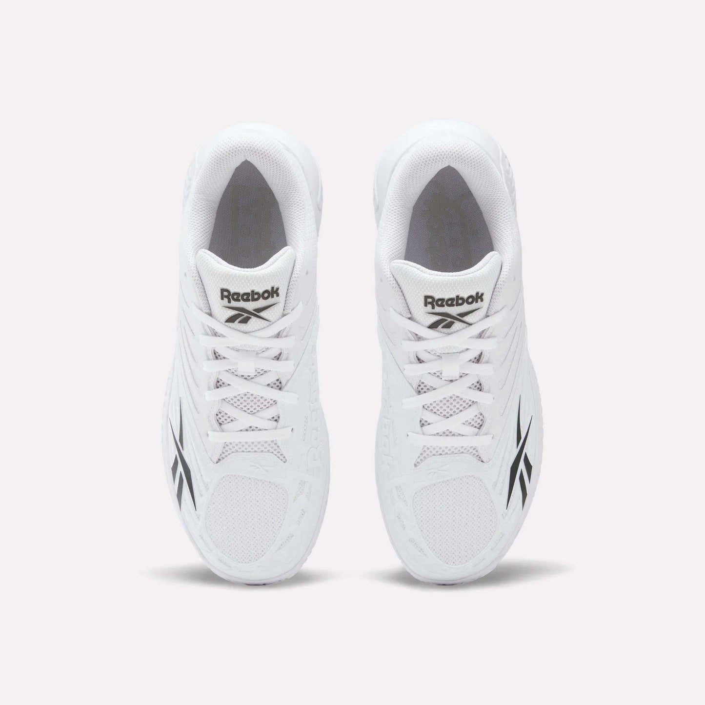 Top view of a pair of Reebok Phase EVO Tennis Shoes in white with black Reebok logos on the sides and tongue, displayed side by side on a plain white background.