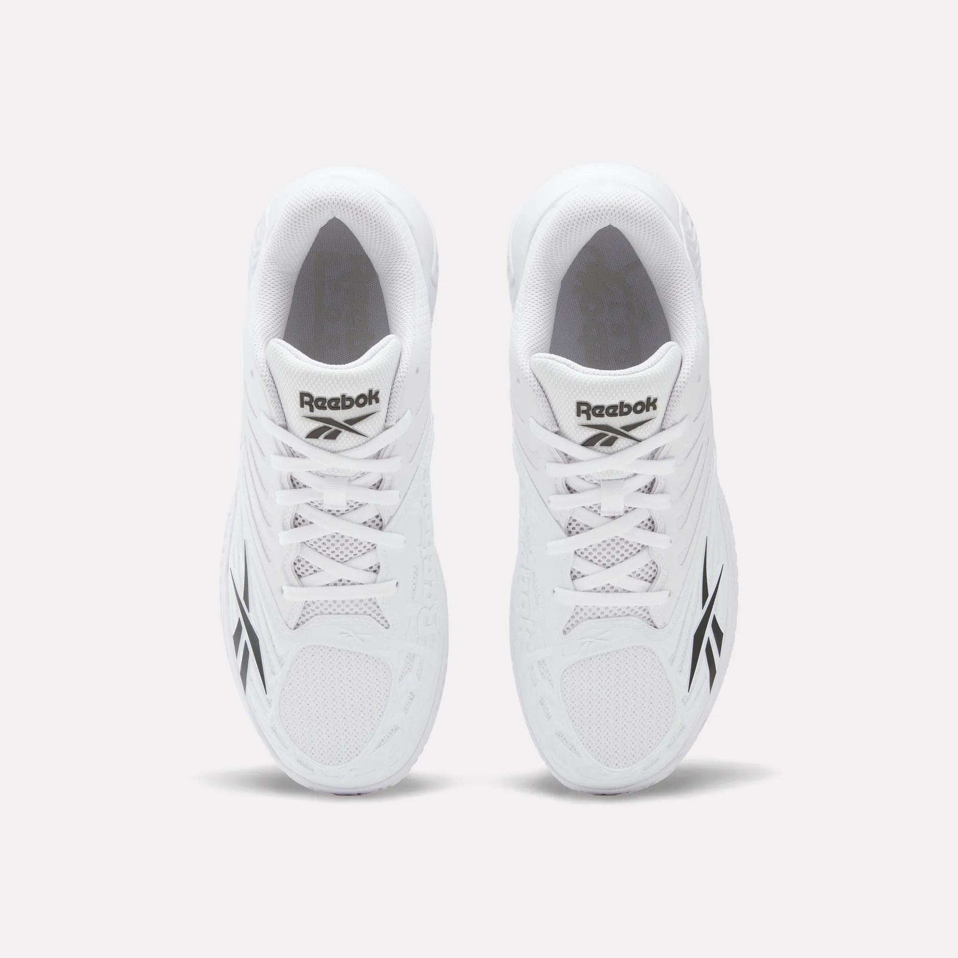 Top view of a pair of Reebok Phase EVO Tennis Shoes in white with black Reebok logos on the sides and tongue, displayed side by side on a plain white background.