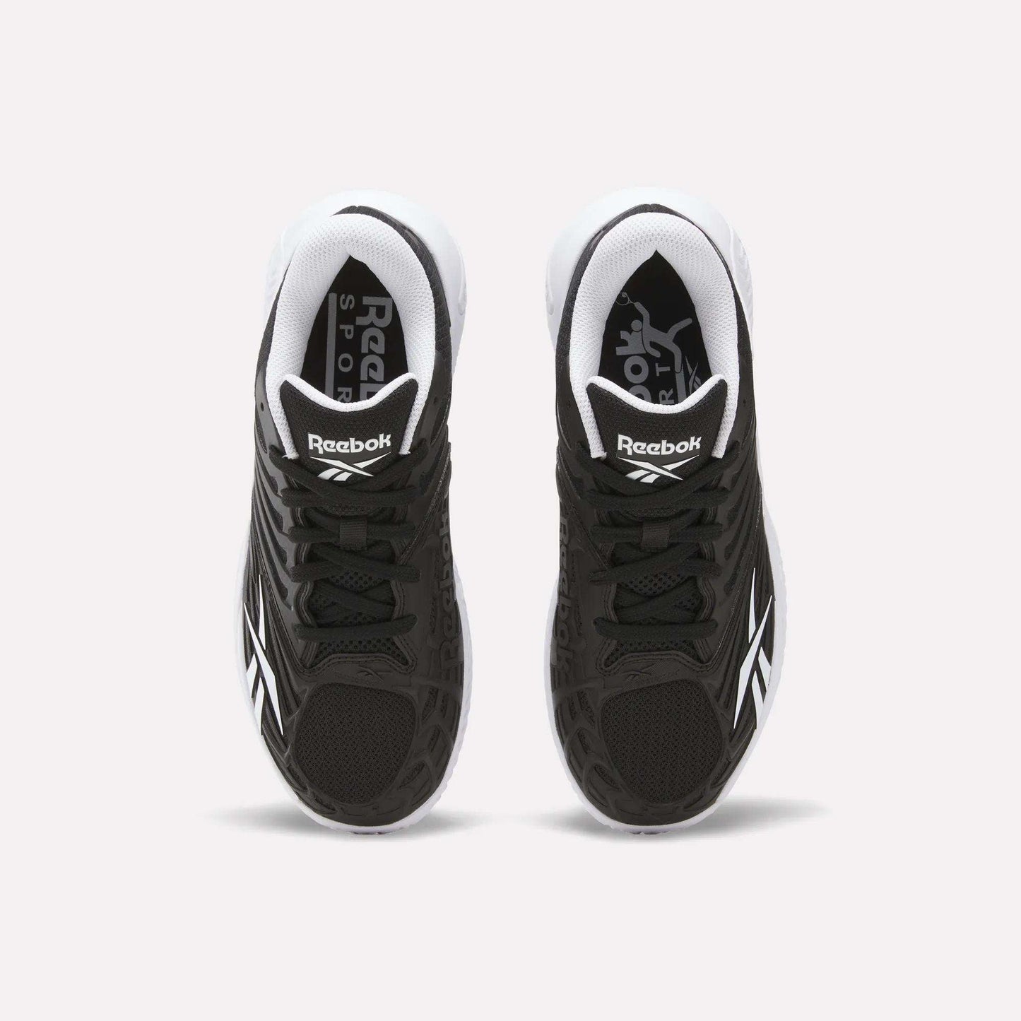 A pair of Reebok Women's Phase Evo Tennis Shoes in black with white accents is shown from above on a light background, featuring the Reebok logo on the tongue and side.