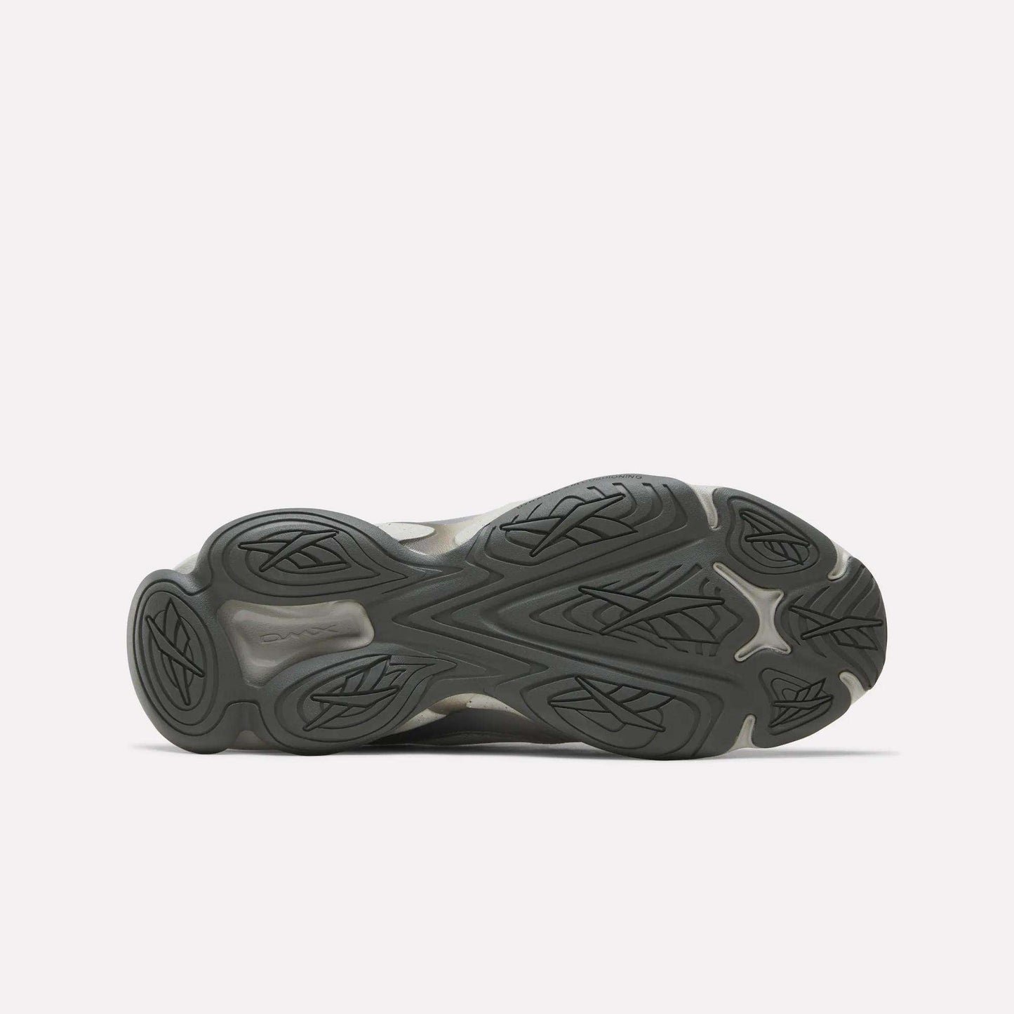 The image shows the sole of the Reebok Mita Sneakers x DMX Series 3000 Shoes, with a dark rubber outsole featuring wavy, grooved traction patterns and leaf-like designs against a plain white background.