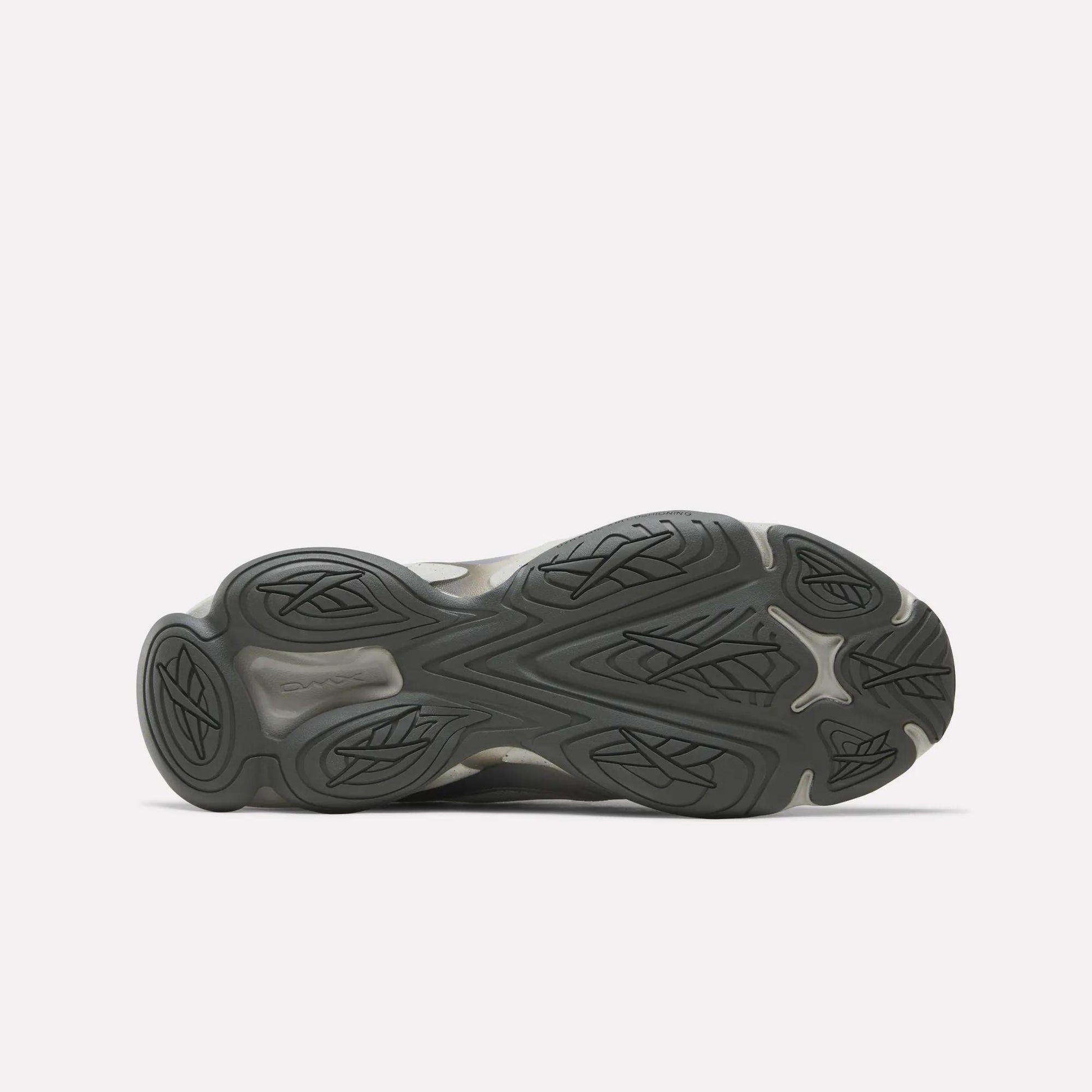 The image shows the sole of the Reebok Mita Sneakers x DMX Series 3000 Shoes, with a dark rubber outsole featuring wavy, grooved traction patterns and leaf-like designs against a plain white background.