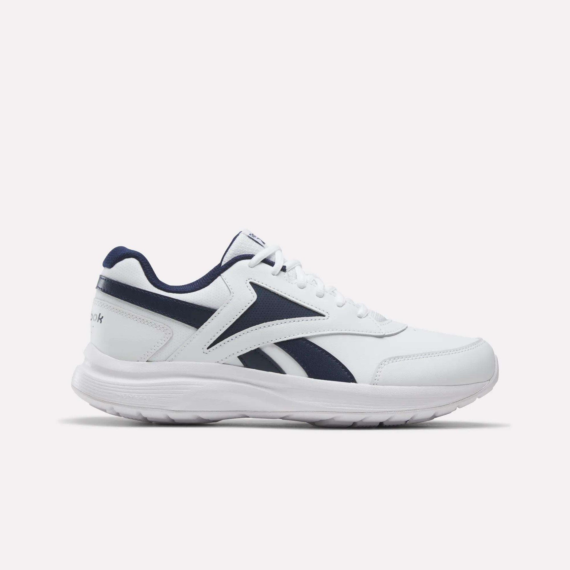 The Men's Walk Ultra 7 DMX Max Shoes by Reebok are shown from the side on a plain light background, featuring a white design with Collegiate Navy and Collegiate Royal accents and a thick sole. These men's shoes come equipped with DMX cushioning for superior comfort, making them an excellent choice for cushioned everyday walking.