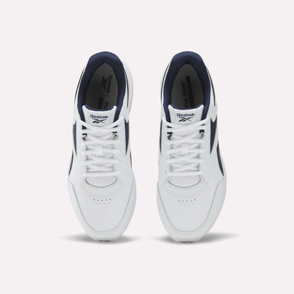 A top-down view of the Men's Walk Ultra 7 DMX Max Shoes by Reebok, featuring a white design with navy blue accents and DMX cushioning, displays the tops and laces of both shoes against a plain white background.