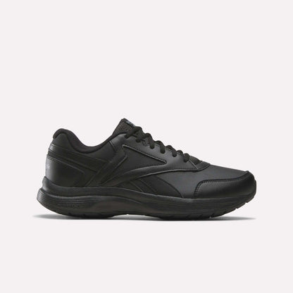 A side view of the Reebok Men's Walk Ultra 7 DMX Max Shoes - Wide 4E in Black/Cold Grey 5/Collegiate Royal is displayed on a plain white background, showcasing its lace-up design, low-cut profile, and textured sole with DMX cushioning for enhanced comfort.