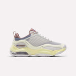 Introducing the Reebok Women's DMX Series 3000 Training Shoes—a stylish athletic shoe featuring a cream-toned New Grey mesh upper accented with Raw Yellow and Hazy Blue details. Designed with layered textures, a translucent sole, and a chunky silhouette, these shoes combine modern aesthetics with the signature cushioned comfort of Reebok walking shoes.