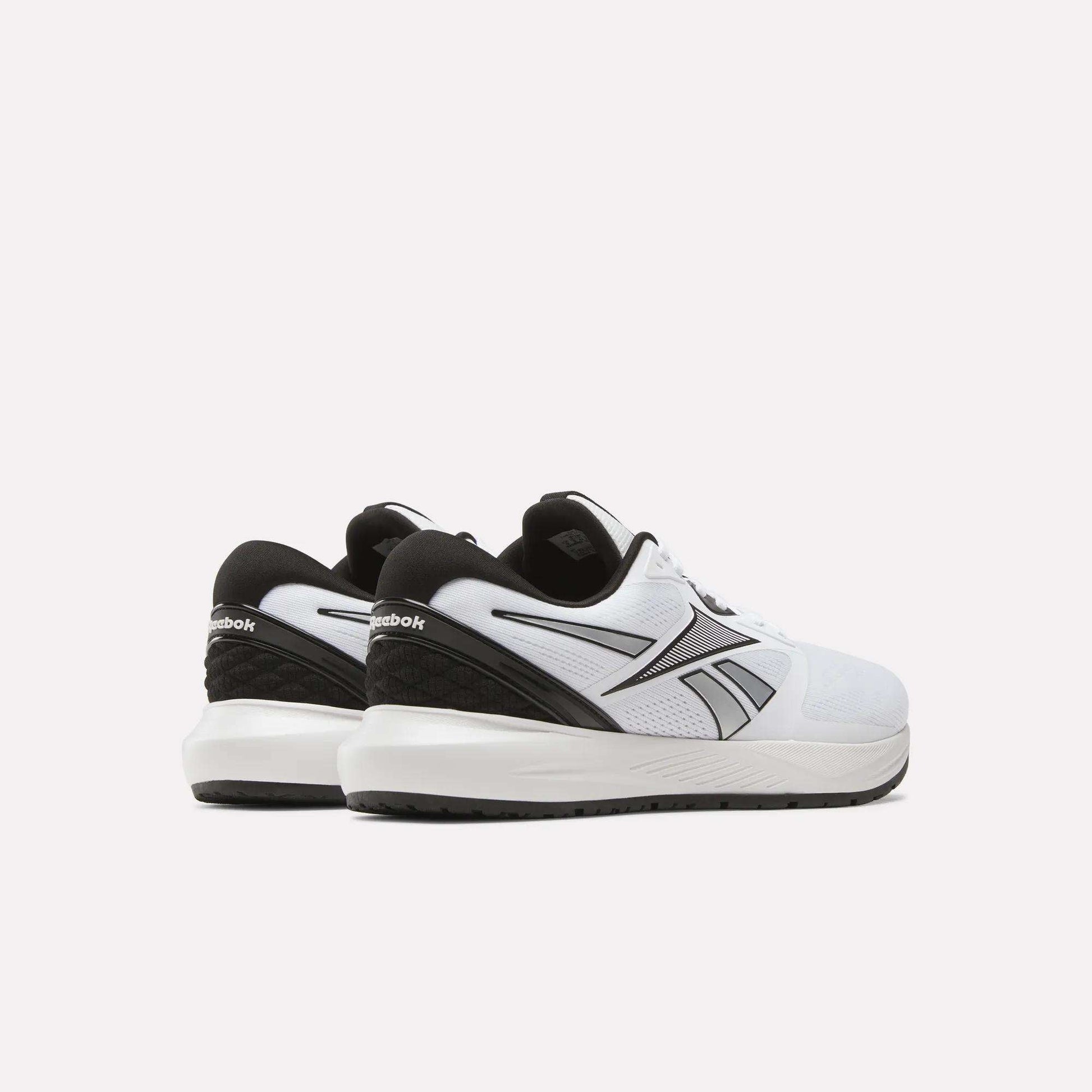 A pair of Reebok Men's Nanoflex 2 Training Shoes in white with black accents, made with breathable mesh and shown from the back and side against a simple light background.