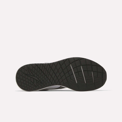 The image displays the underside of a black Reebok Men's Nanoflex 2 Training Shoe, featuring a textured, grid-like sole pattern designed for traction and durability. The shoe is set against a plain white background.