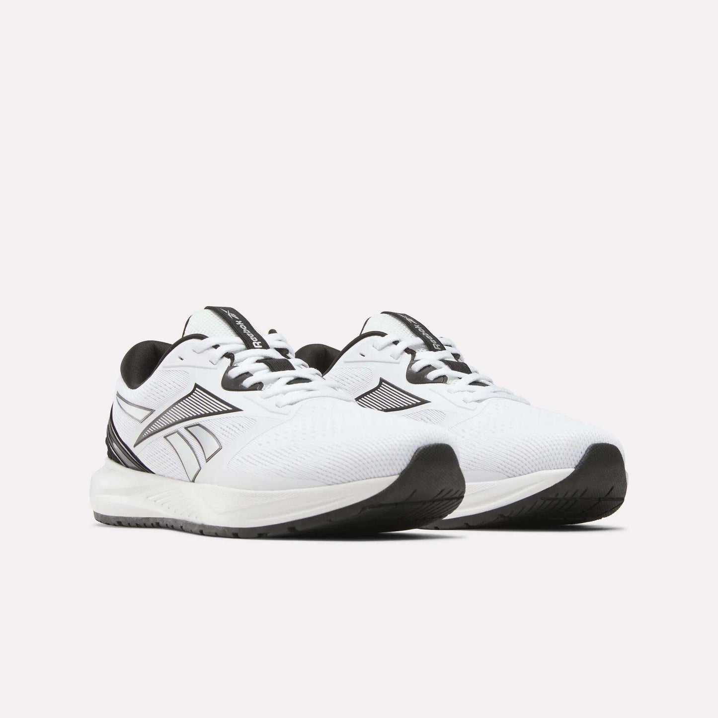 A pair of Reebok Men's Nanoflex 2 Training Shoes in white, highlighted by black accents, breathable mesh uppers, sturdy black soles, and a signature black Reebok logo on the sides—ideal for workouts—displayed against a light background.