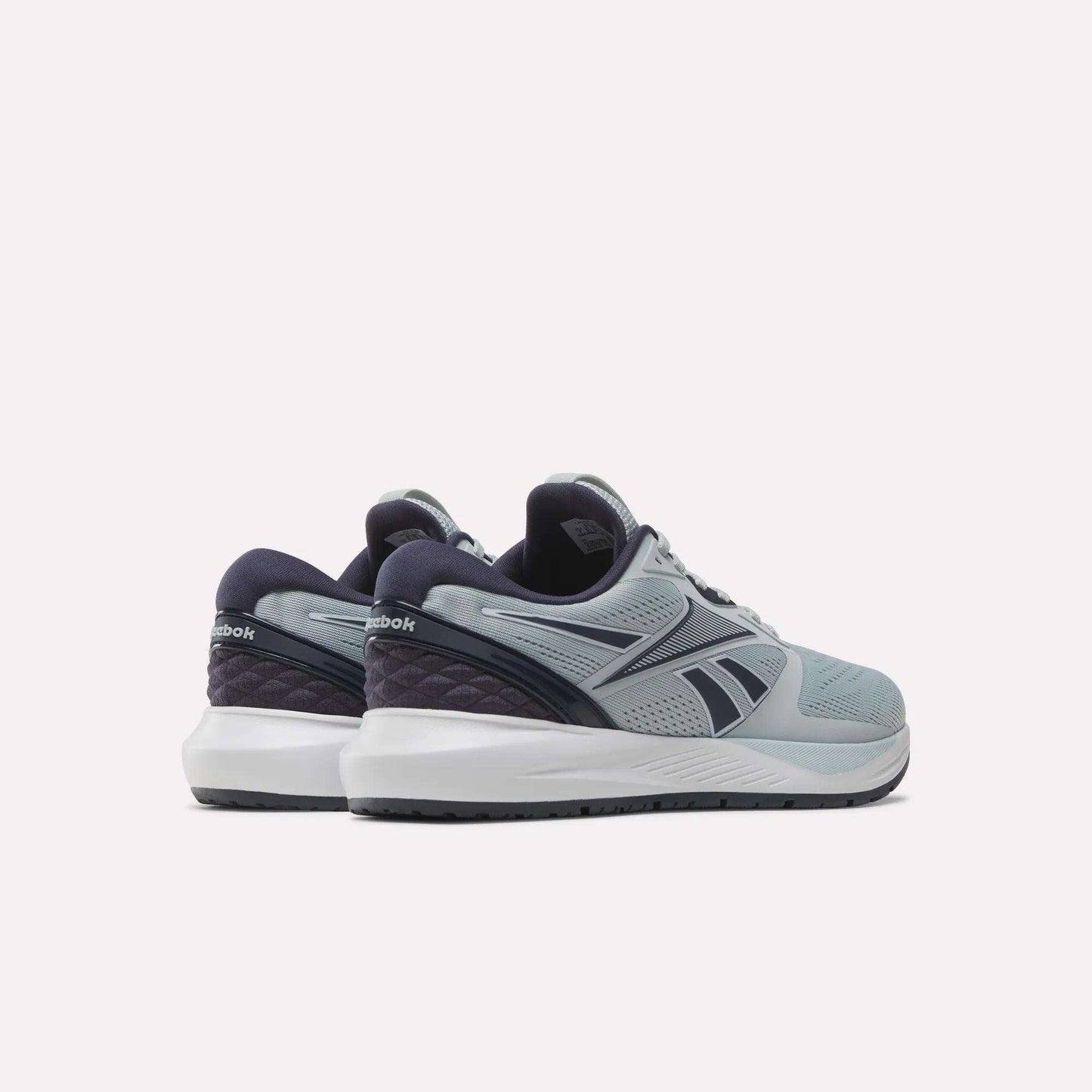 A pair of Reebok Women's NFX Trainer 2 Training Shoes in light blue and navy, displayed from the back and side angles, featuring white midsoles and dark outsoles, set against a plain white background.