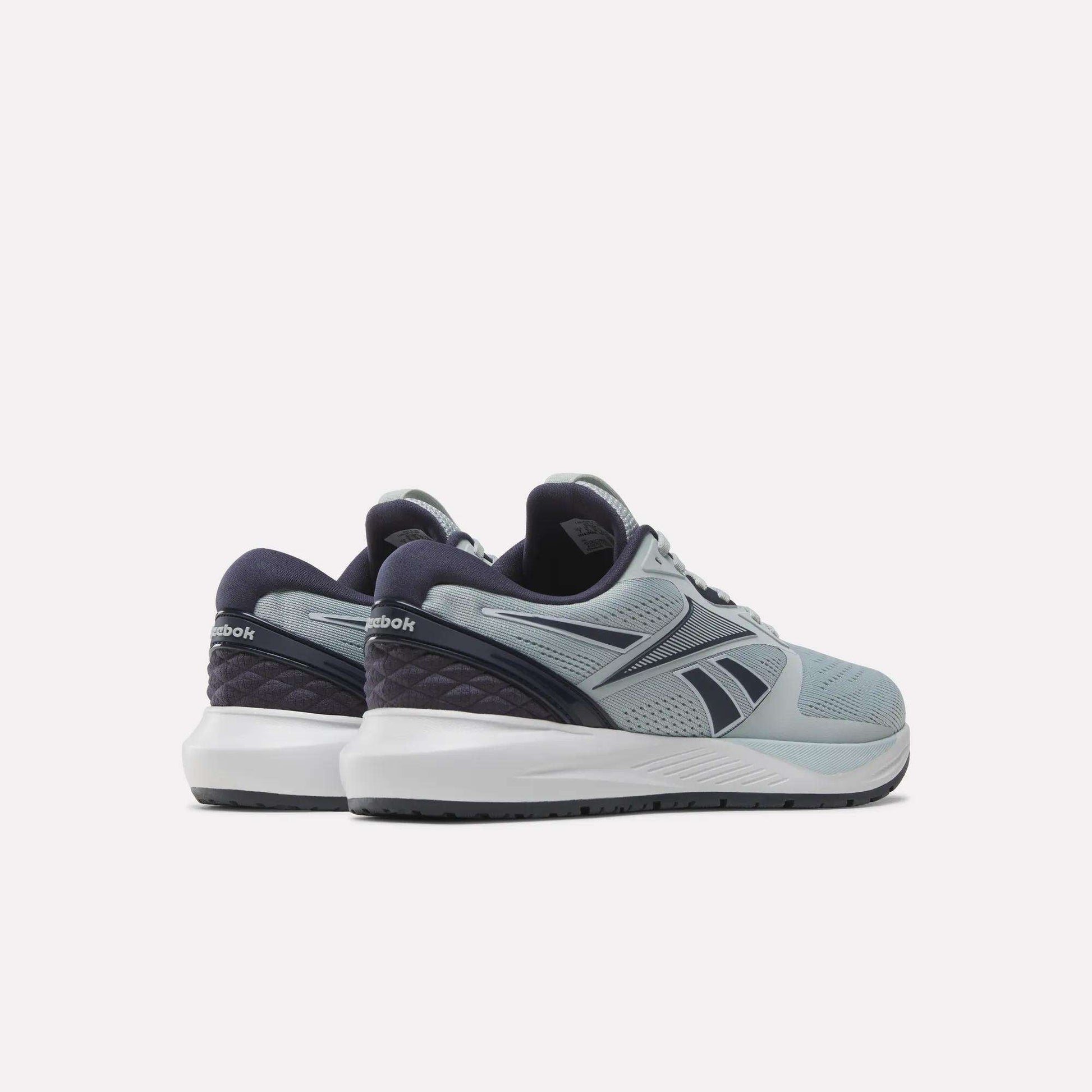 A pair of Reebok Women's NFX Trainer 2 Training Shoes in light blue and navy, displayed from the back and side angles, featuring white midsoles and dark outsoles, set against a plain white background.