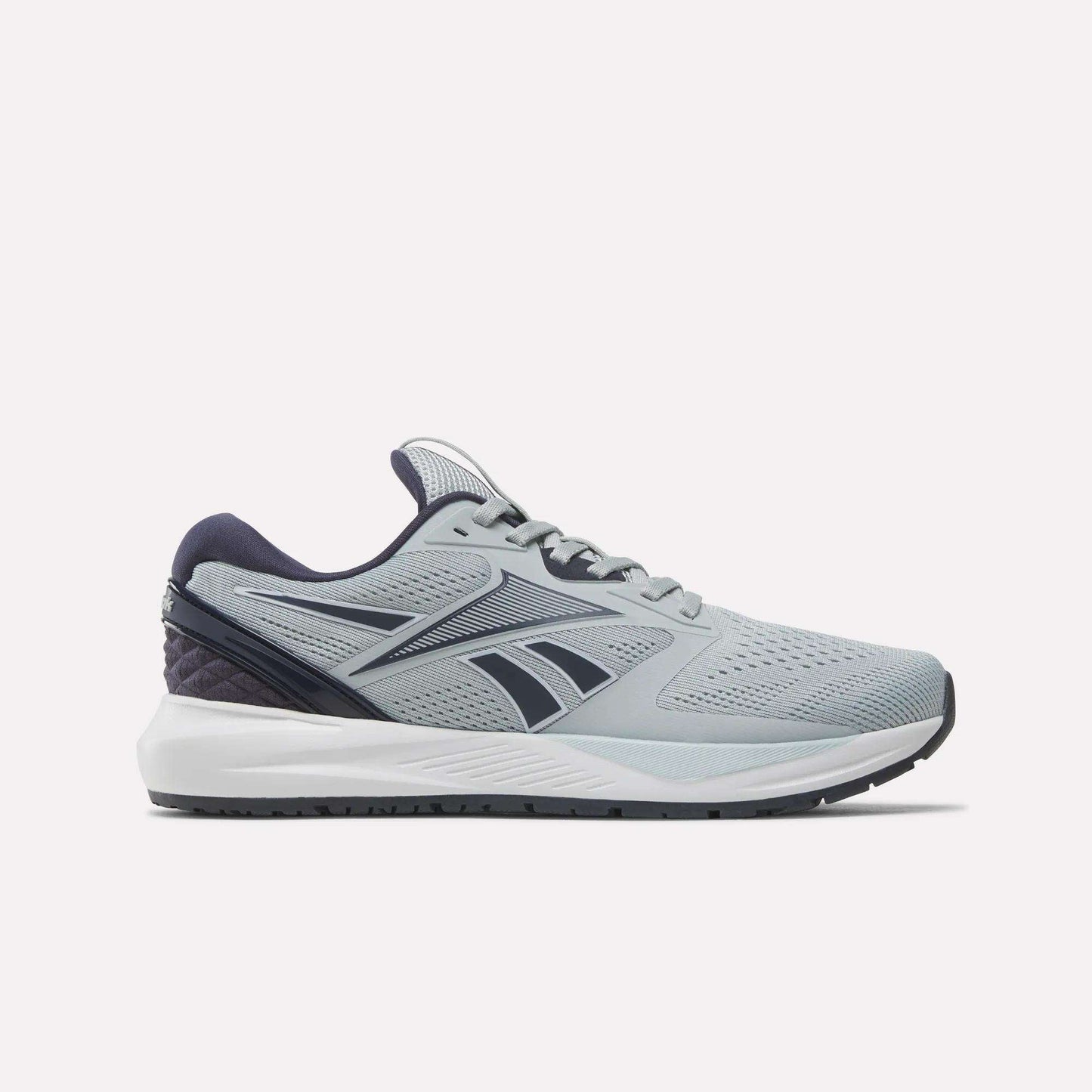 The Women's NFX Trainer 2 Training Shoes by Reebok are grey athletic sneakers with black and navy accents, showcasing a breathable mesh upper and the signature Reebok logo on the sides. They feature a white sole and are displayed from a side view against a plain white background—ideal as versatile training shoes.