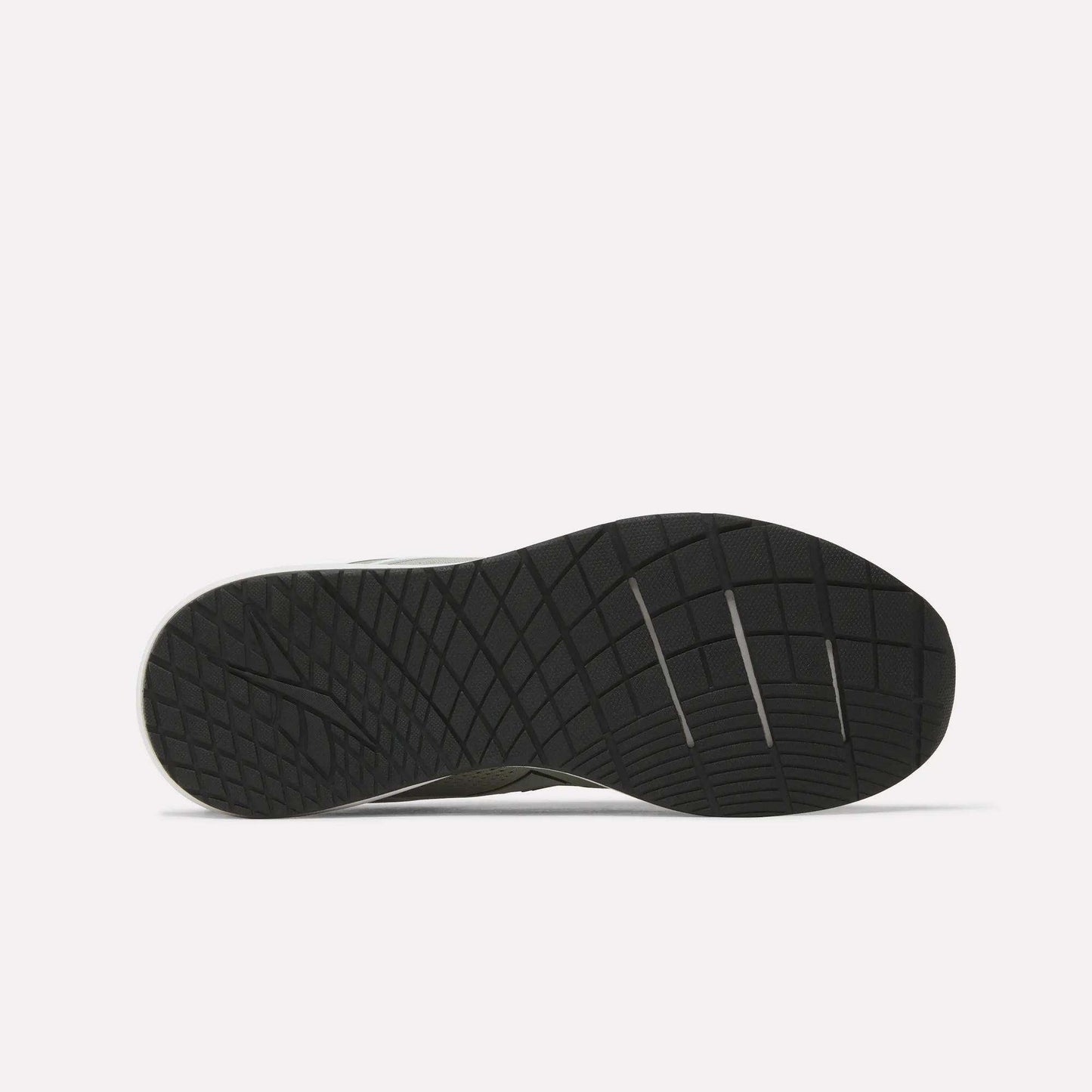 The image displays the black rubber outsole of a Reebok Men's Nanoflex 2 Training Shoe, highlighting its geometric tread pattern and several horizontal flex grooves, set against a plain white background.
