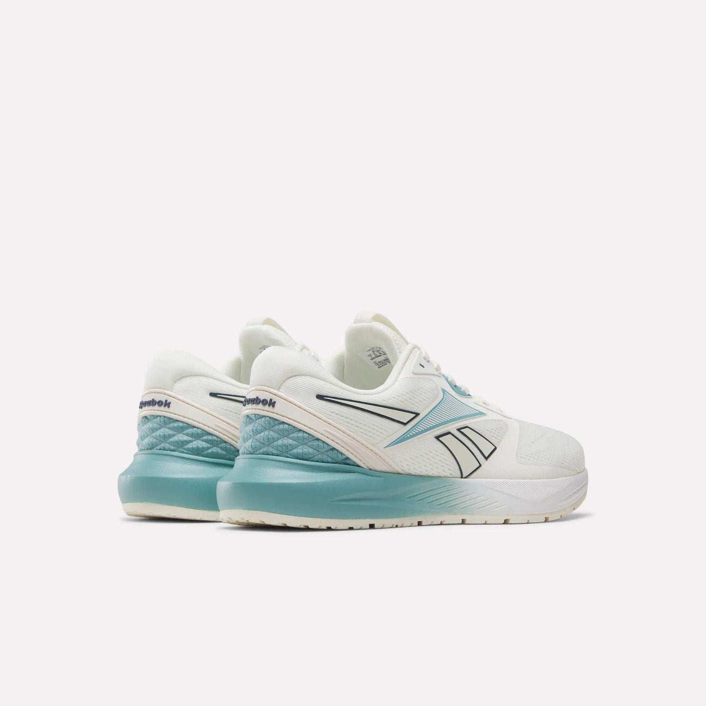Two white Women's Nanoflex 2.0 Training Shoes by Reebok with teal accents are displayed on a white background, seen from the back and side to highlight the Reebok logo and gradient teal heel design. Ideal as women's training footwear, these stylish Reebok workout shoes combine comfort and performance for your active lifestyle.