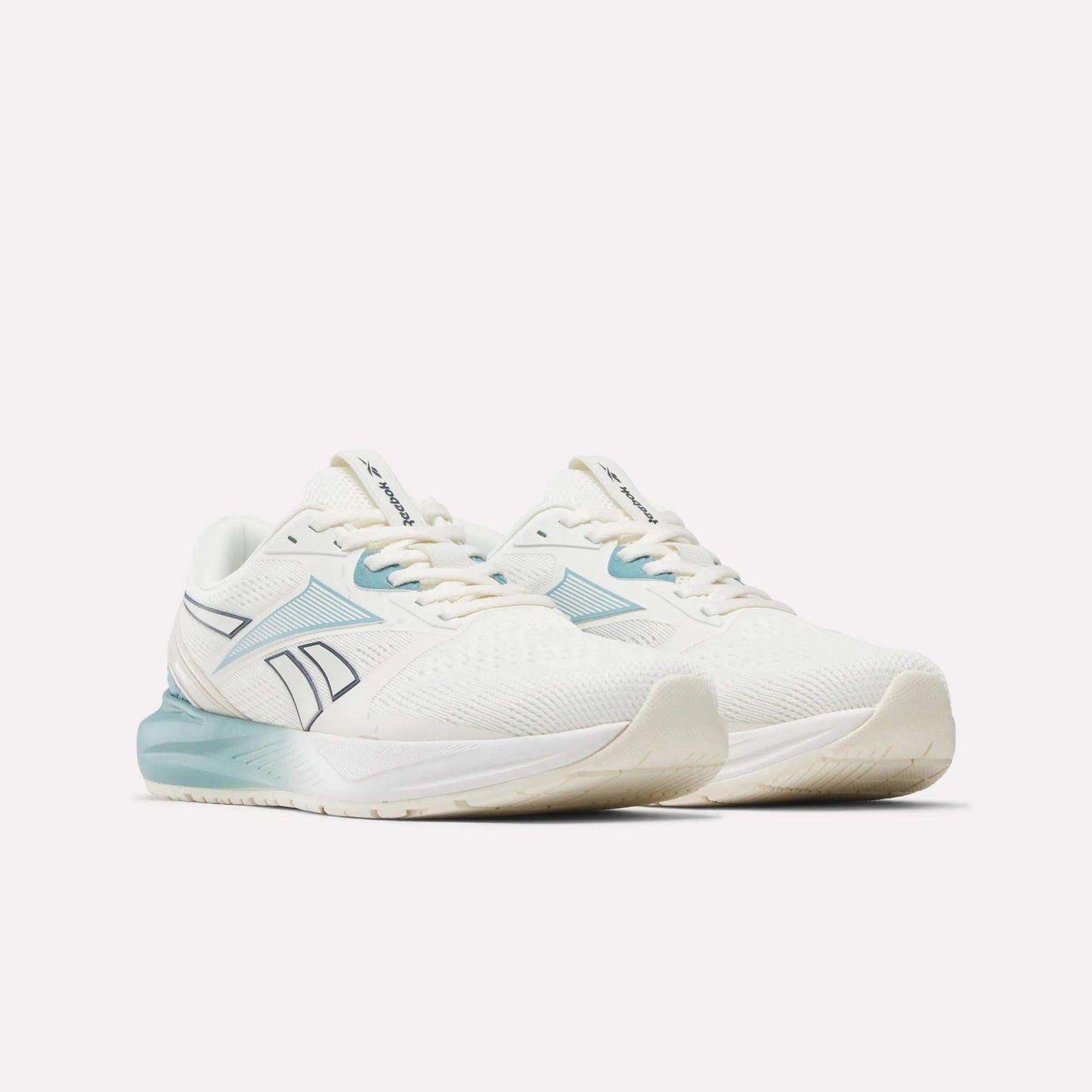 A pair of Reebok Women's Nanoflex 2.0 Training Shoes in white with light blue accents and a blue logo, displayed at an angle to showcase the sides and front against a plain white background—these athletic sneakers are ideal for training or as dependable workout footwear.