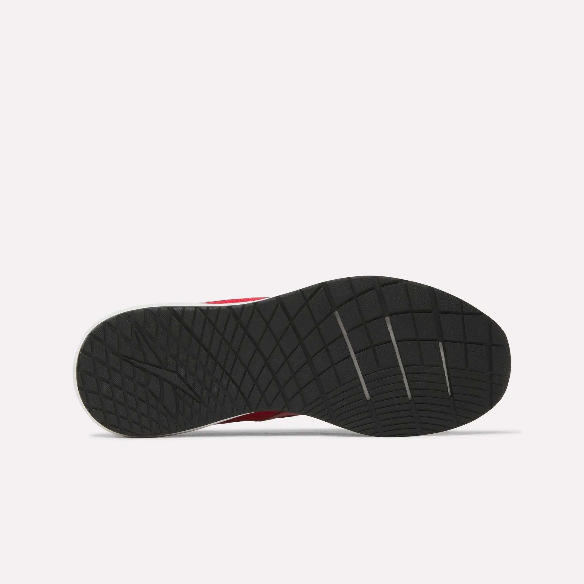 Bottom view of a black rubber sole from the Reebok Men's Nanoflex 2 Training Shoes, showcasing a textured, grid-like tread pattern with several diagonal grooves, set against a plain white background.