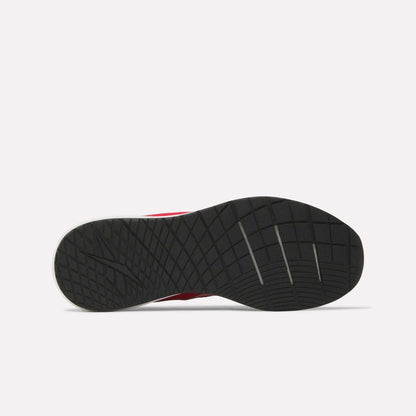 Bottom view of a black rubber sole from the Reebok Men's Nanoflex 2 Training Shoes, showcasing a textured, grid-like tread pattern with several diagonal grooves, set against a plain white background.