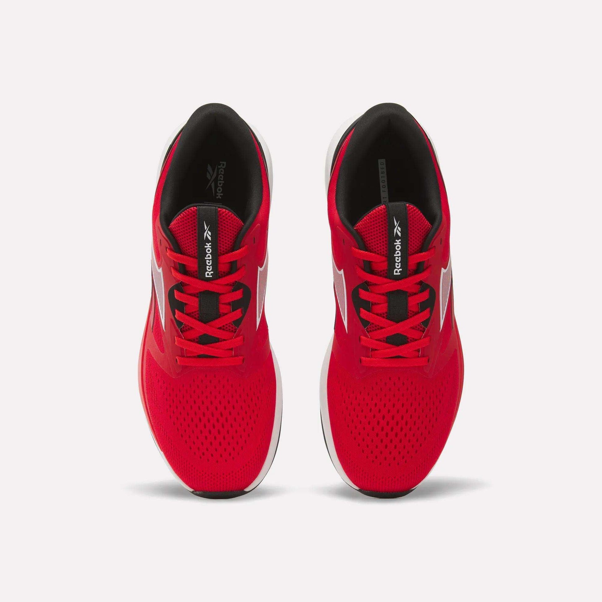 Top view of a pair of Men's Nanoflex 2 Training Shoes by Reebok in bright red, featuring white soles, black interiors, and black Reebok logos on the tongues, displayed side by side on a white background.