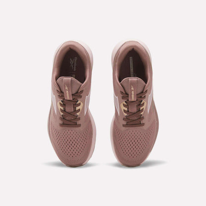A pair of Reebok Women's Nanoflex 2.0 Training Shoes in pink, shown from above with white side stripes, brown laces, and perforated toes for breathability on a plain white background.