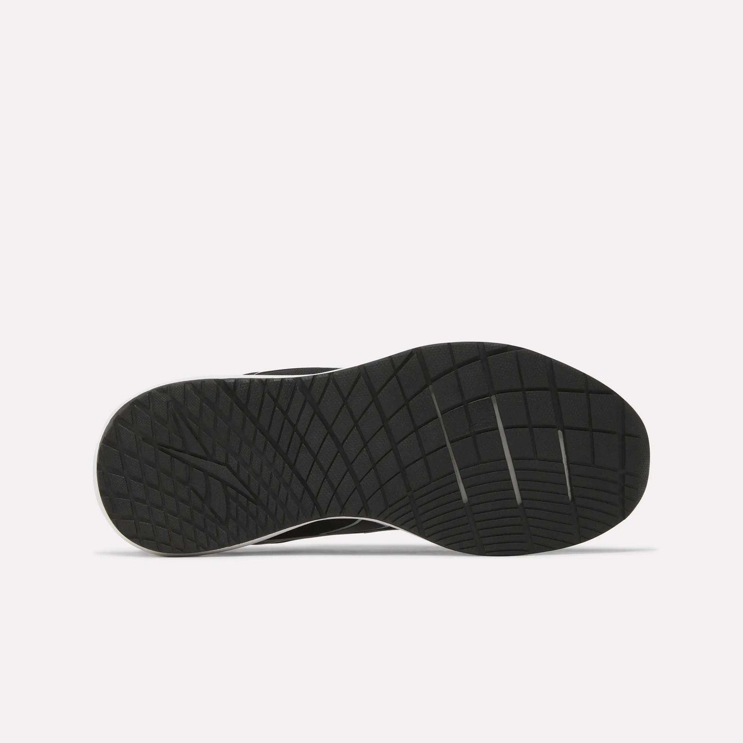 The sole of the Reebok Women's NFX Trainer 2 Training Shoes is shown from the bottom, displaying a textured pattern with geometric lines and grooves for enhanced traction against a plain white background.