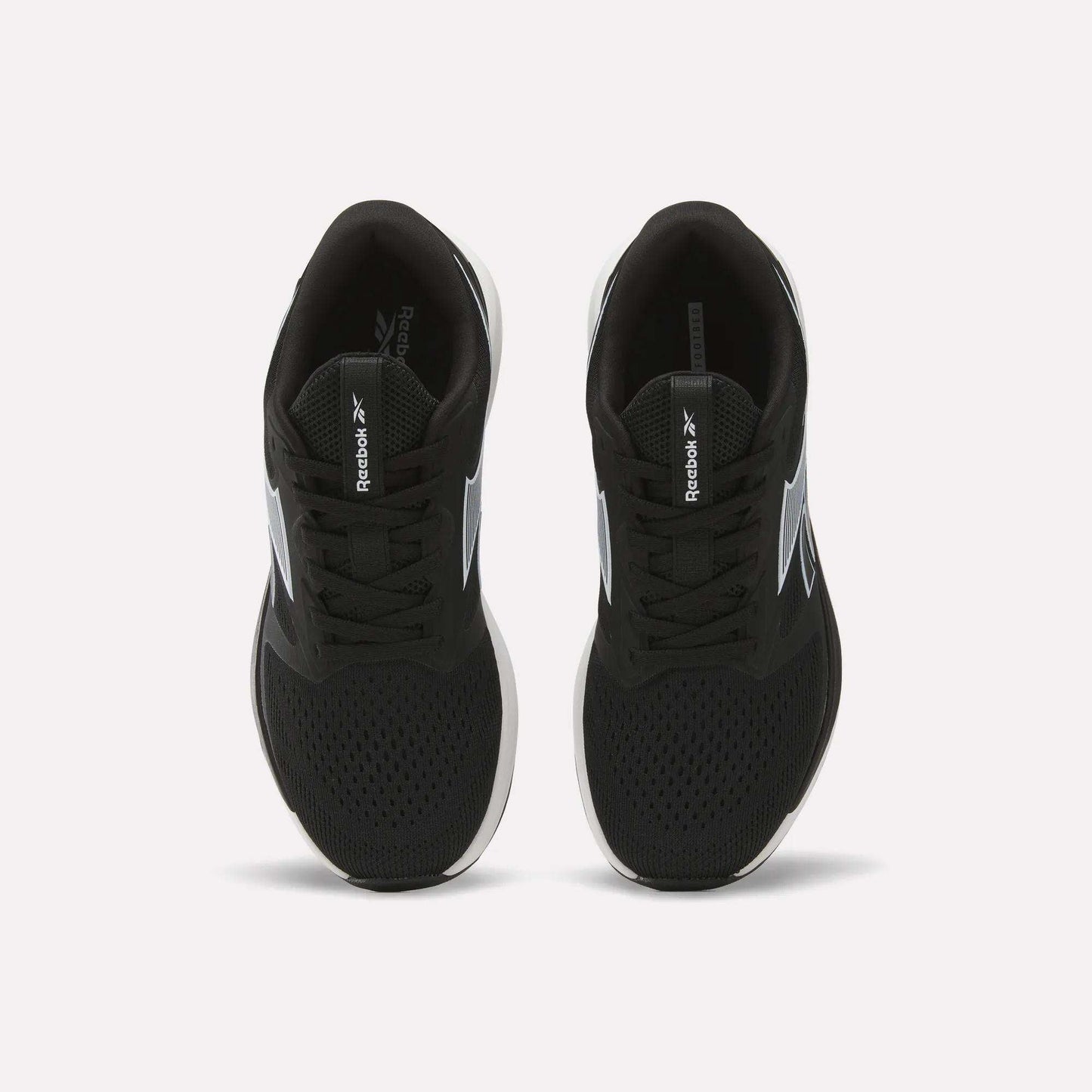 A pair of Women's NFX Trainer 2 Training Shoes by Reebok in black, featuring mesh uppers, laces, white soles, and white Reebok logos on the sides as viewed from above.