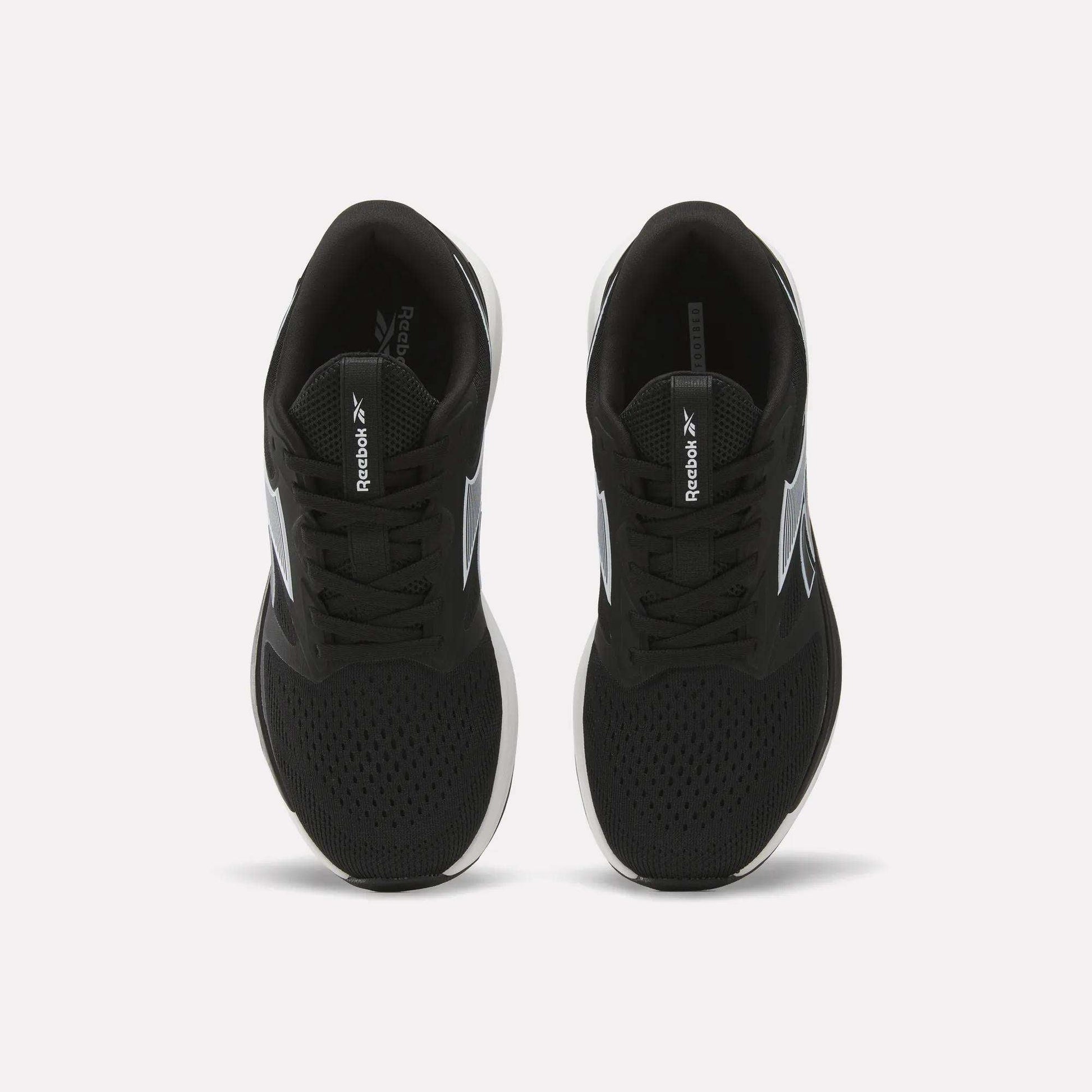 A pair of Women's NFX Trainer 2 Training Shoes by Reebok in black, featuring mesh uppers, laces, white soles, and white Reebok logos on the sides as viewed from above.