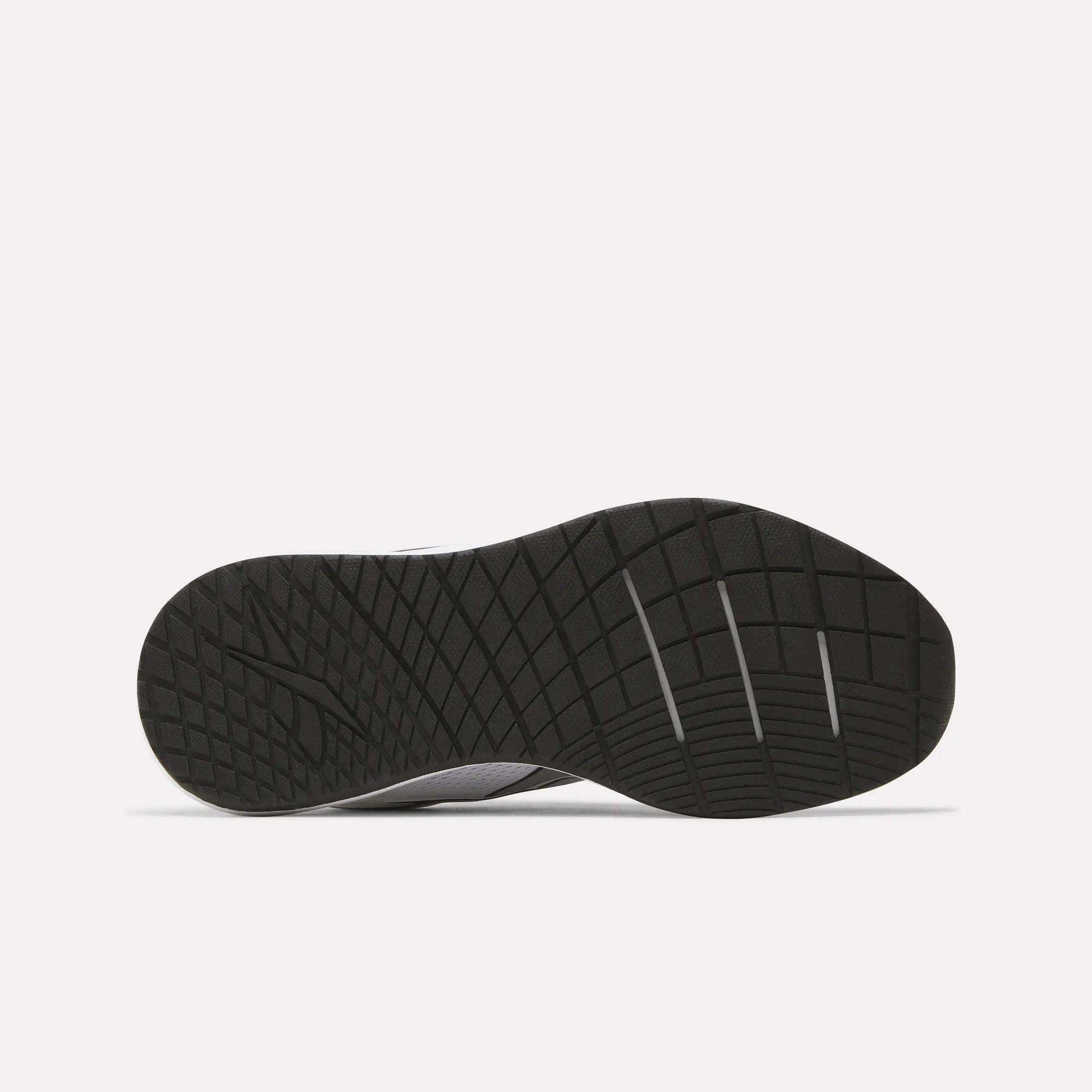 The image displays the black rubber outsole of the Reebok Women's Nanoflex 2.0 Training Shoes, featuring a geometric tread pattern, as seen from the bottom against a plain white background.