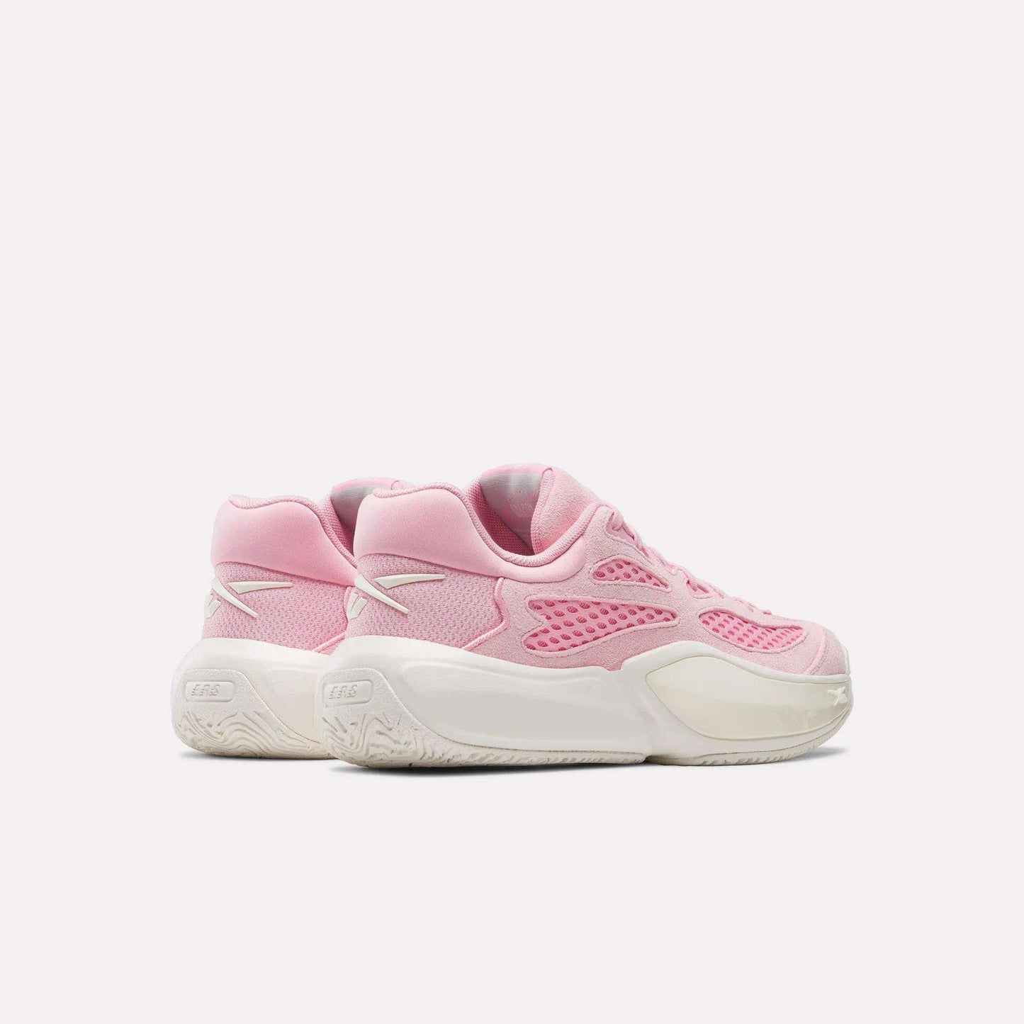 A pair of Reebok Engine A 26 Basketball Shoes in pink with white accents and thick white soles provide excellent stability, displayed side by side on a plain light background.