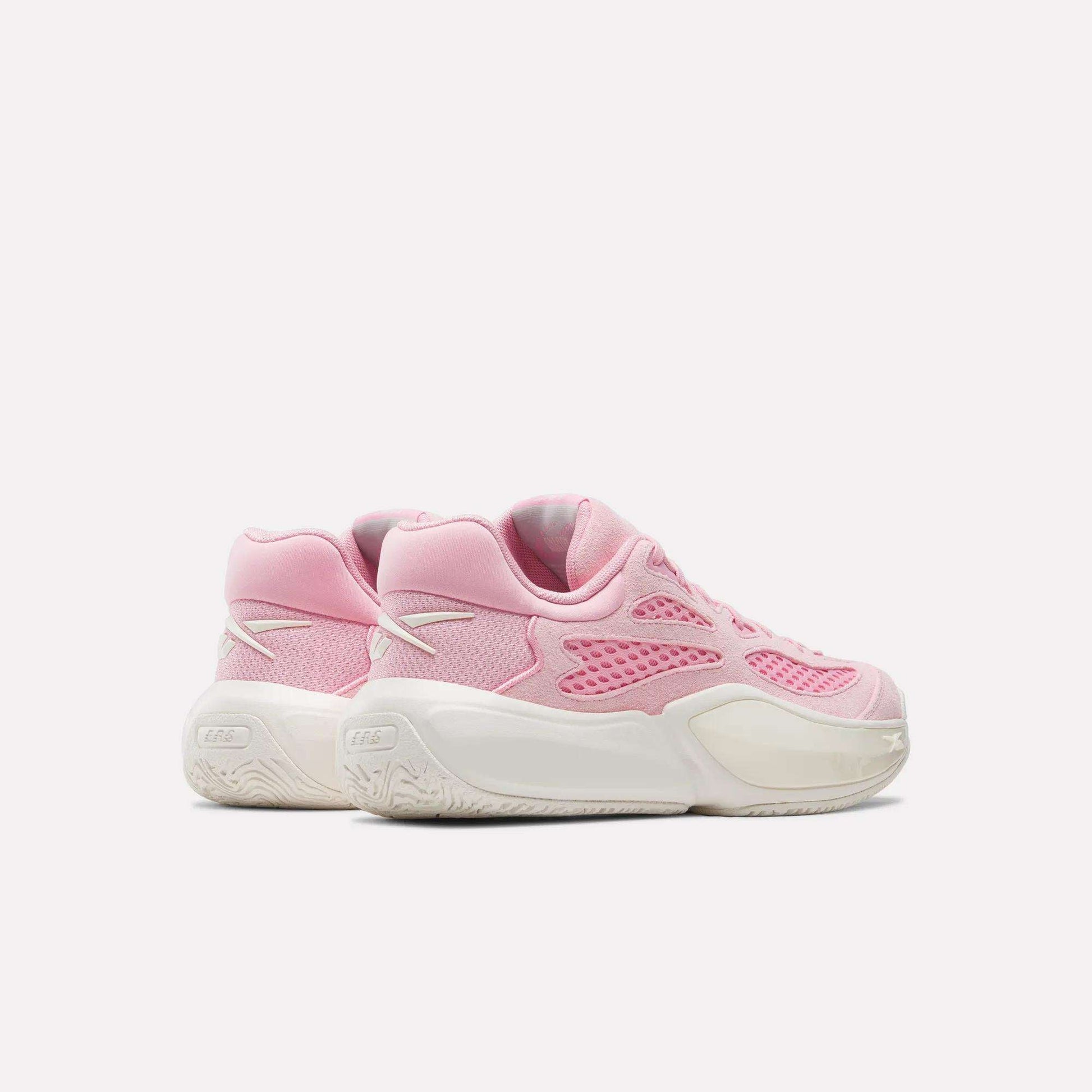 A pair of Reebok Engine A 26 Basketball Shoes in pink with white accents and thick white soles provide excellent stability, displayed side by side on a plain light background.