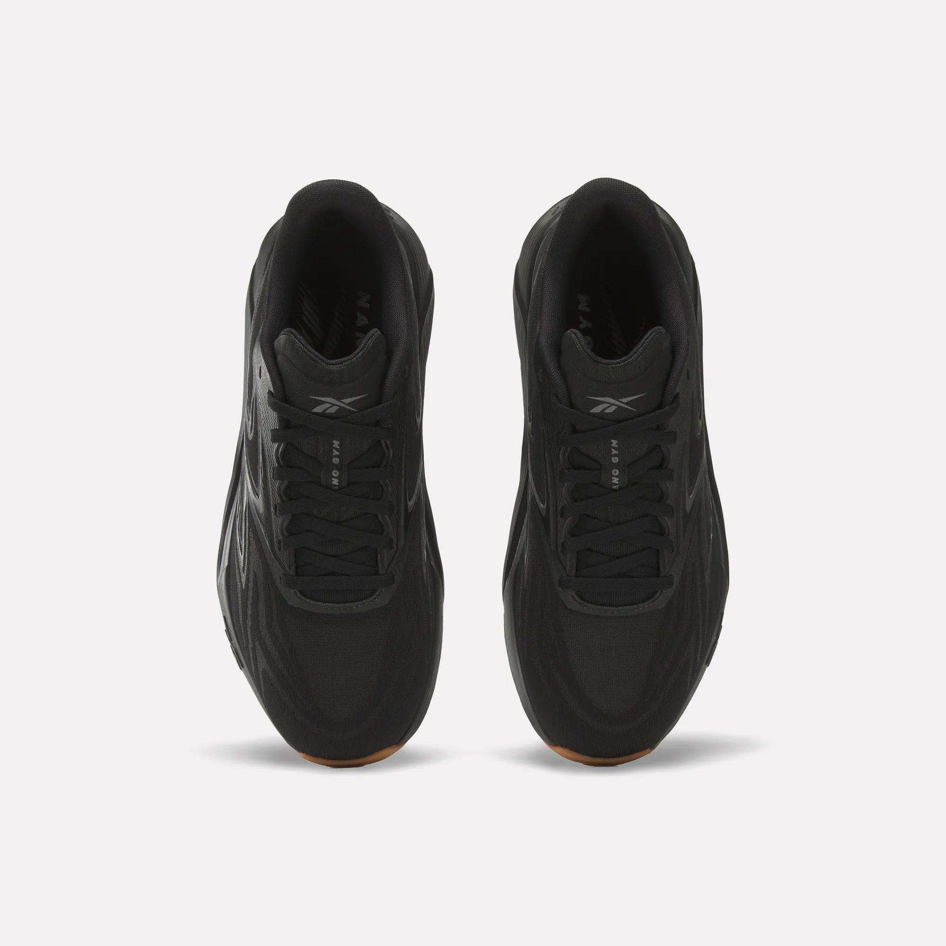Top view of Reebok Nano Gym 2.0 Training Shoes in black with black laces, subtle logo on the tongue, and high-rebound foam cushioning, displayed on a plain white background.