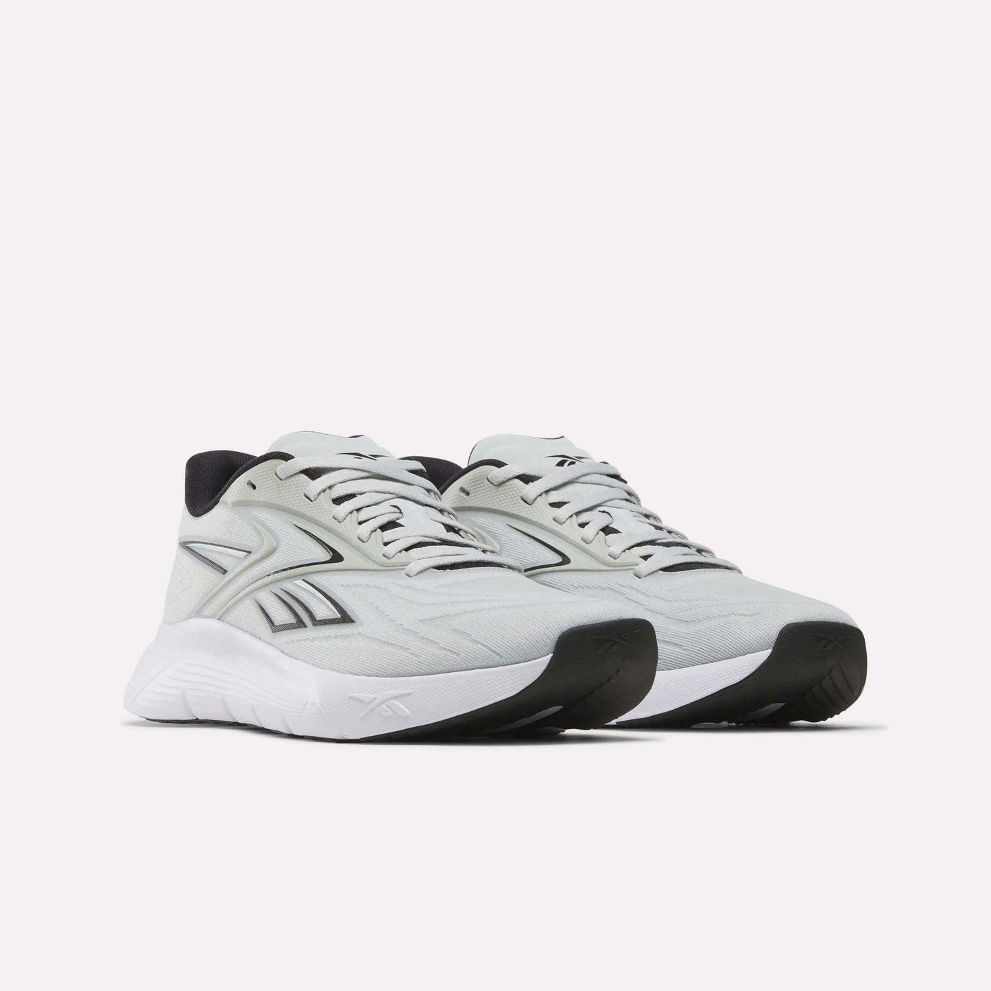 The Reebok Nano Gym 2.0 Training Shoes feature a light gray design with white soles, black accents, and side logos. Shown on a plain white background, they’re perfect for gym workouts or everyday use.