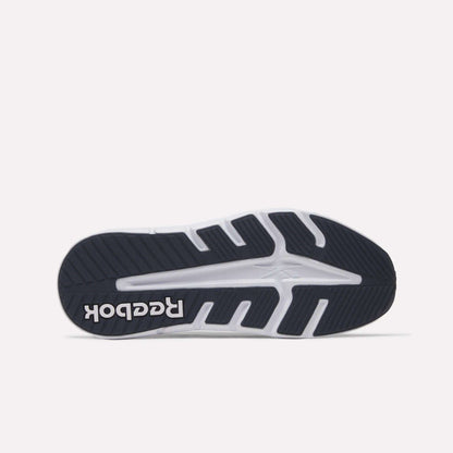 The image displays the sole of the Reebok Nano Gym 2.0 Training Shoe, highlighting its black and white rubber tread with deep grooves and textured patterns, plus a white Reebok logo near the heel.