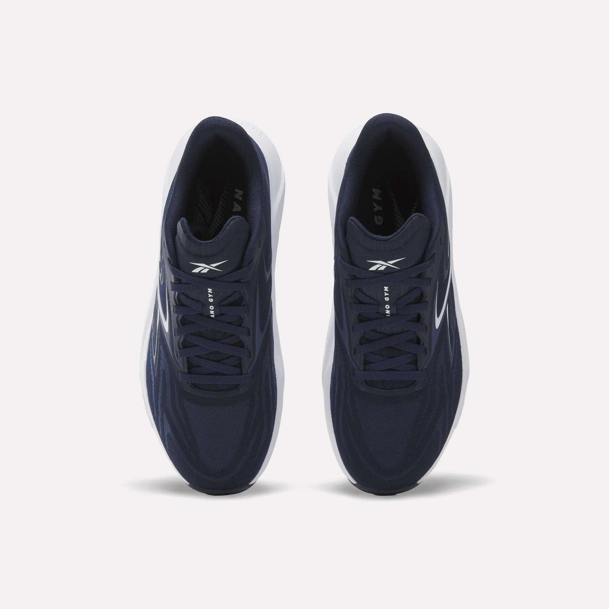A top view shows a pair of Nano Gym 2.0 Training Shoes by Reebok in navy blue with white soles and Reebok logos on the tongues and sides, placed side by side on a plain white background.