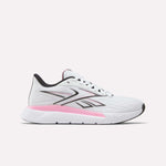 Side view of the Reebok Women's Nano Gym 2.0 Training Shoes in White/Black, showing a lace-up design and low-cut profile with black accents. The midsole features a pink gradient, while the outsole stays mostly white.
