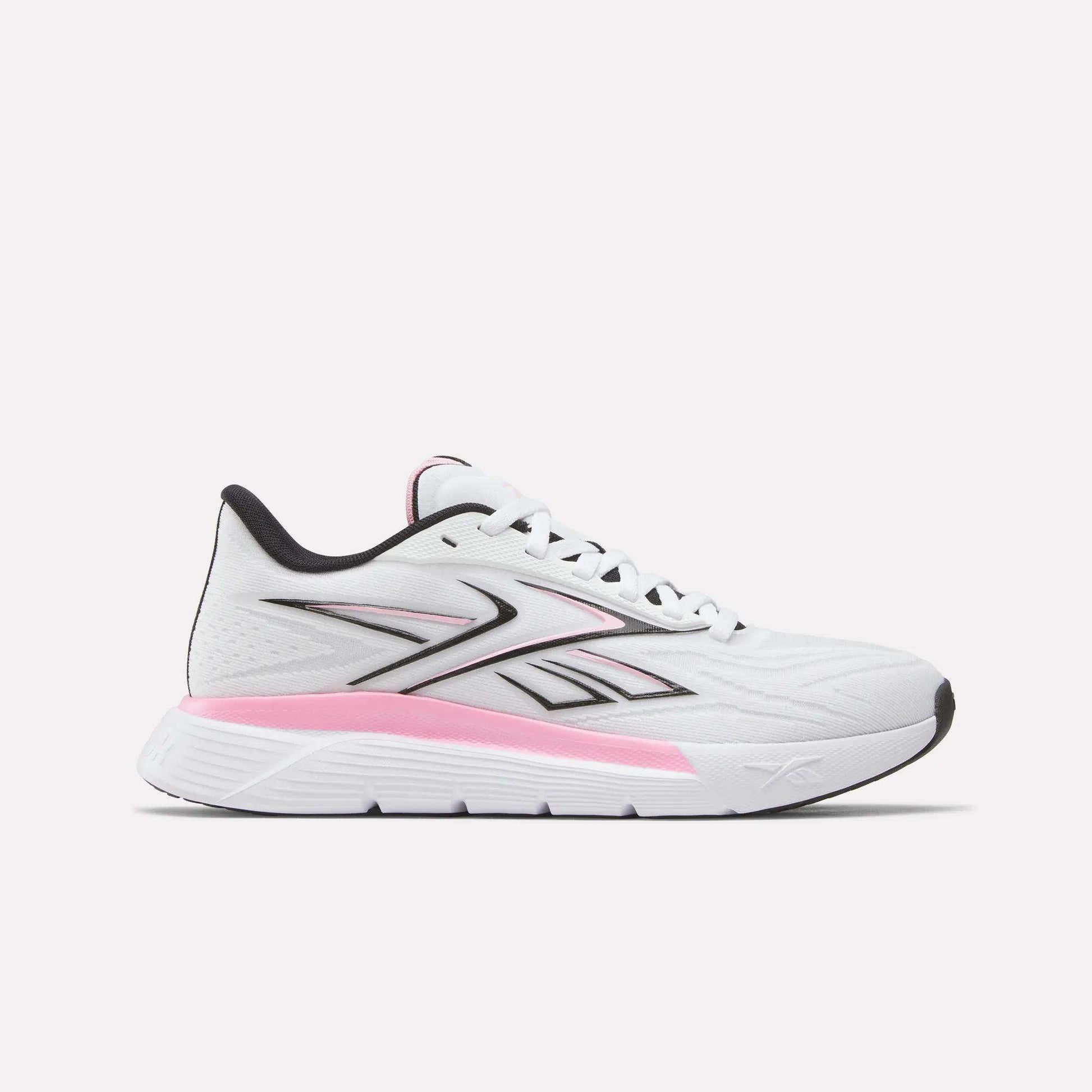 Side view of the Reebok Women's Nano Gym 2.0 Training Shoes in White/Black, showing a lace-up design and low-cut profile with black accents. The midsole features a pink gradient, while the outsole stays mostly white.