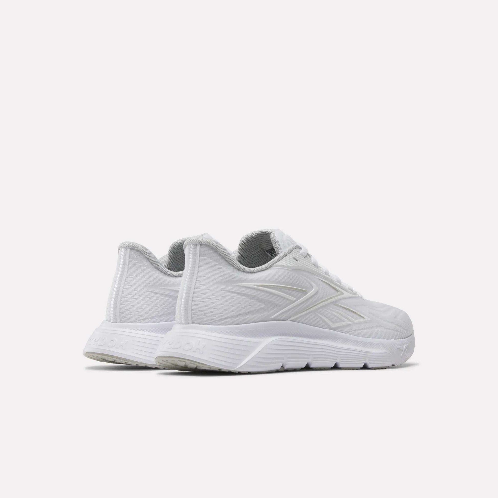 A pair of Reebok Women's Nano Gym 2.0 Training Shoes in white, featuring subtle textured patterns and a grey interior, displayed side by side on a light background from back and side views—ideal for your next workout.